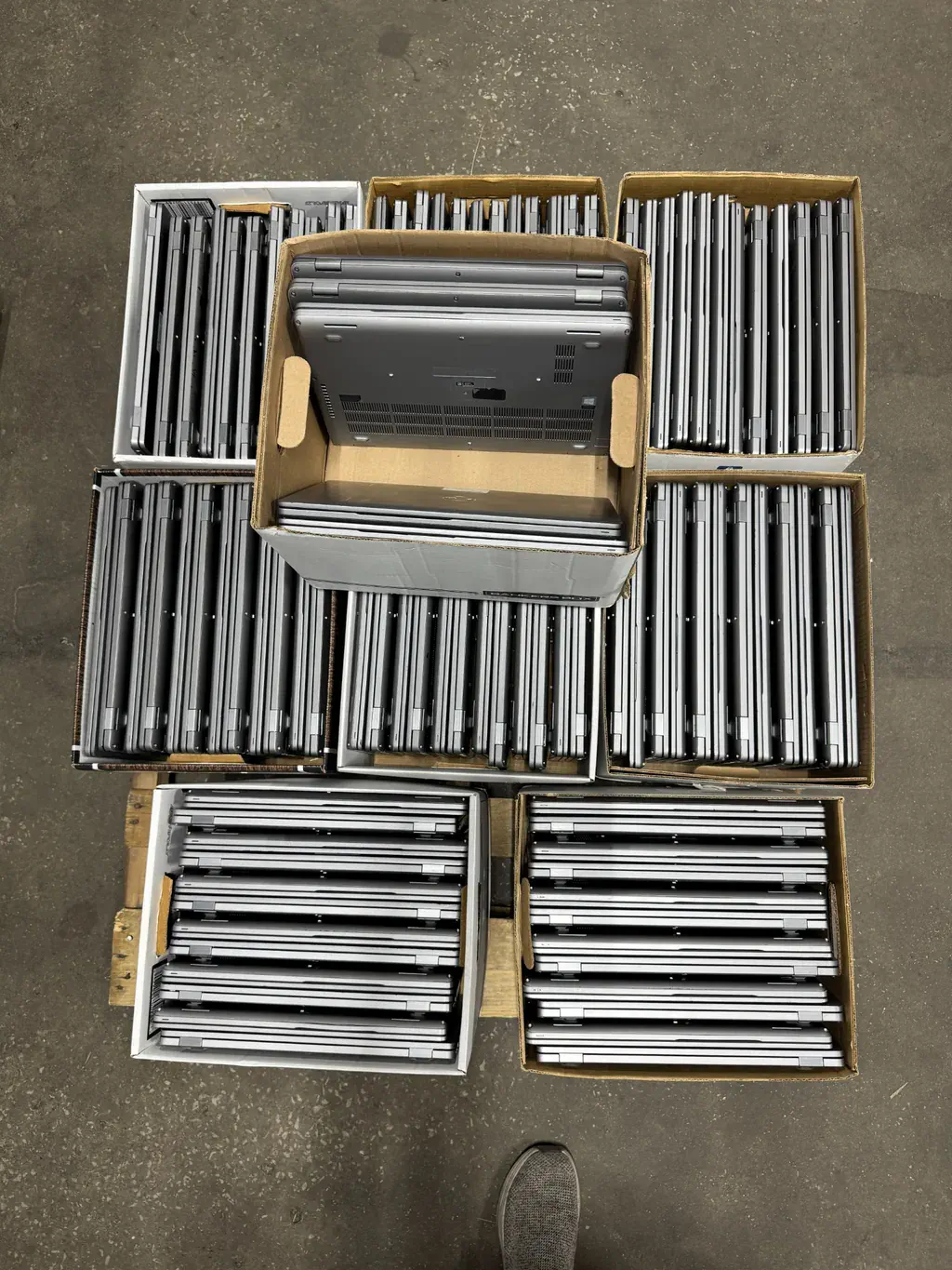 Boxed laptop inventory staged for business ITAD processing