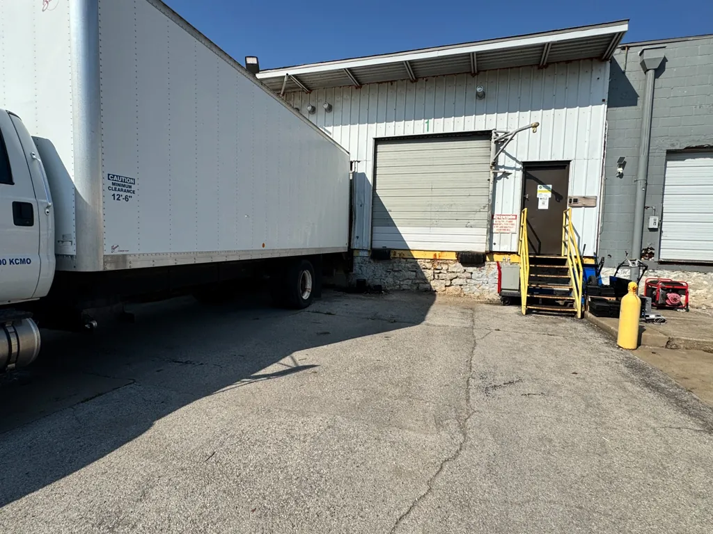 Go to the dock bay unloading area with the box truck